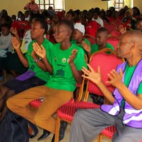 Young people applaud at a forum