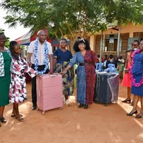 Officials hand over suitcases to learners